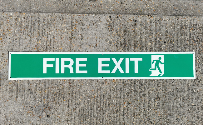 Fire Exit sign laid flat on the ground